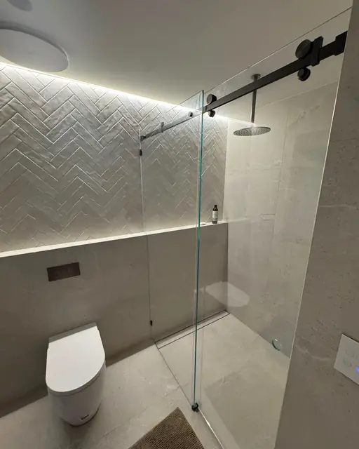 Walk-in shower with a rain head and wall-hung toilet