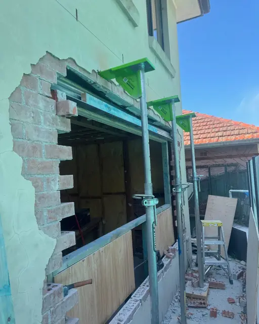 Structural opening with a steel lintel and props holding the load
