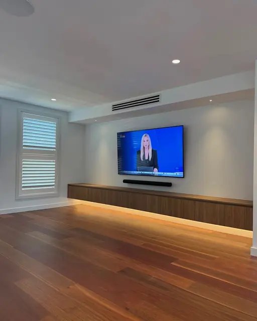Finished living room with floating joinery, concealed LED and hardwood floors